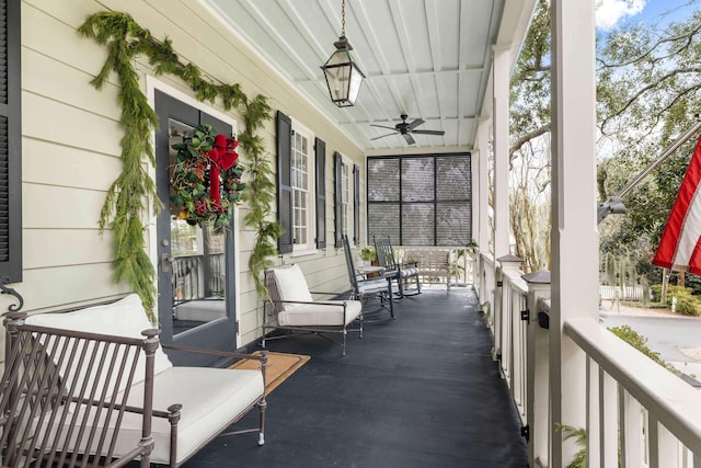 sunroom / solarium featuring ceiling fan