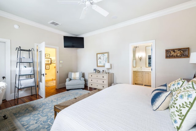 bedroom featuring hardwood / wood-style flooring, ensuite bath, ornamental molding, and ceiling fan