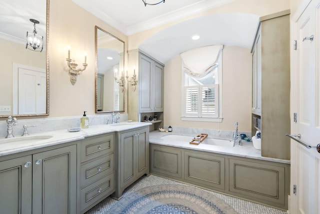 bathroom with an inviting chandelier, vanity, a washtub, and ornamental molding