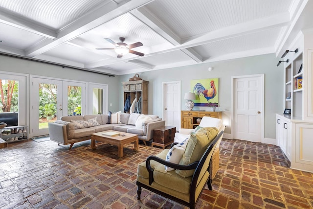 living room with french doors, ceiling fan, a barn door, and beamed ceiling