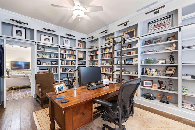 office space featuring hardwood / wood-style floors, ornamental molding, and ceiling fan