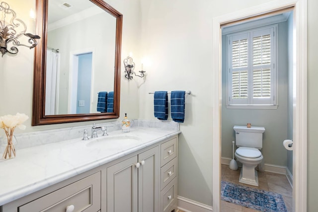 bathroom with tile patterned flooring, vanity, and toilet