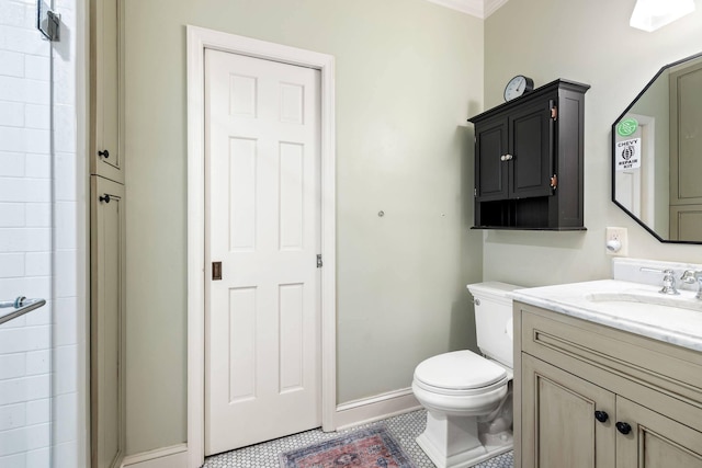 bathroom featuring tile patterned floors, vanity, toilet, and a shower with shower door