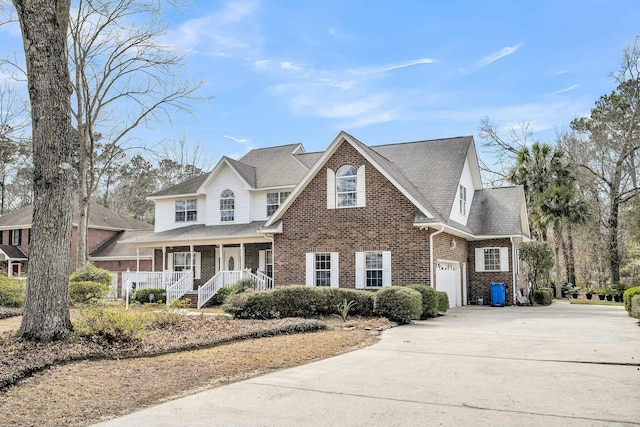 view of front facade featuring brick siding, a porch, a shingled roof, concrete driveway, and a garage