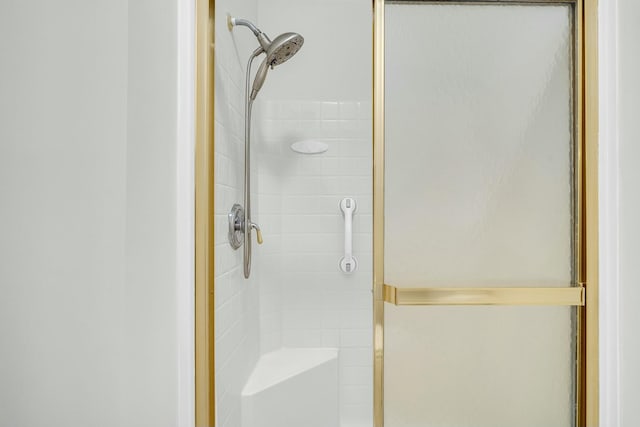 bathroom featuring a shower with door