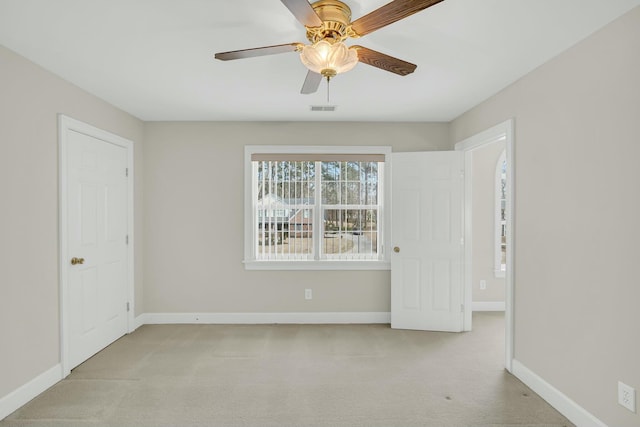 interior space with a ceiling fan, visible vents, and baseboards