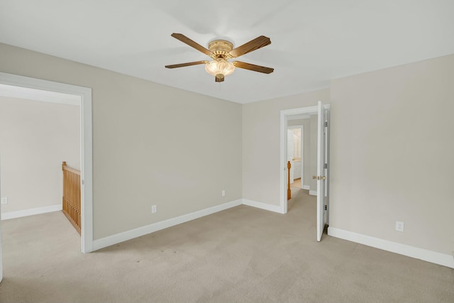 unfurnished bedroom with light carpet, ceiling fan, and baseboards