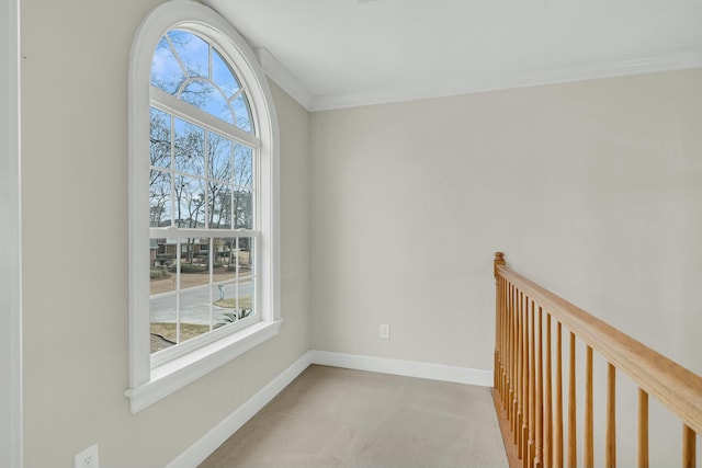 hallway with crown molding and baseboards