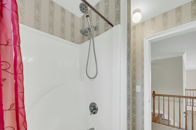 bathroom featuring ornamental molding, bathing tub / shower combination, and wallpapered walls