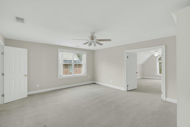 unfurnished room with baseboards, ceiling fan, visible vents, and light colored carpet