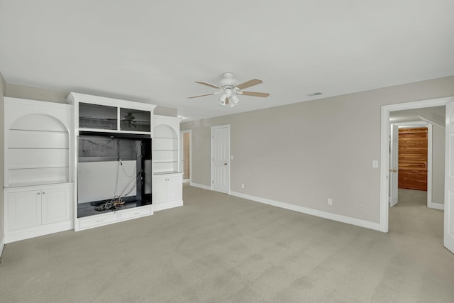 unfurnished living room featuring a ceiling fan, light colored carpet, visible vents, and baseboards