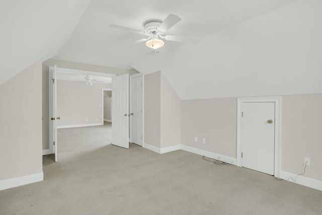 bonus room featuring light carpet, vaulted ceiling, and baseboards