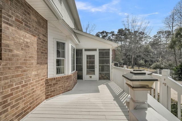 wooden deck with a sunroom