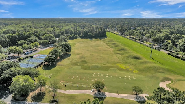 birds eye view of property featuring a view of trees