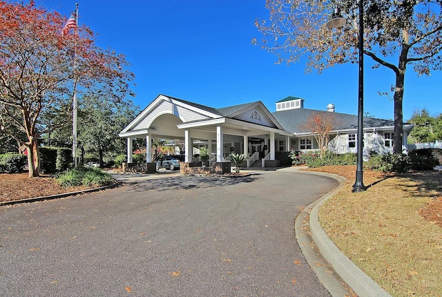 view of building exterior with aphalt driveway and a carport