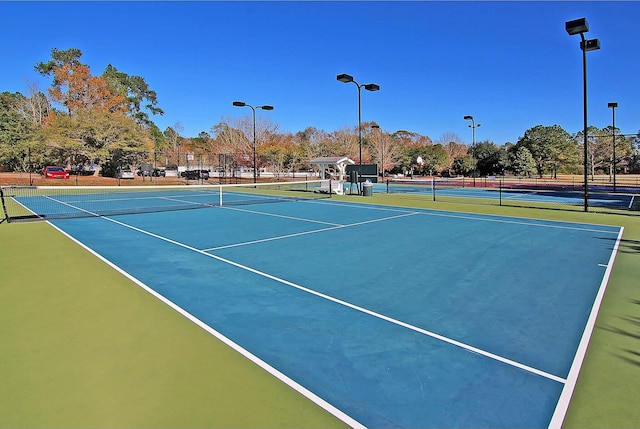 view of sport court featuring fence