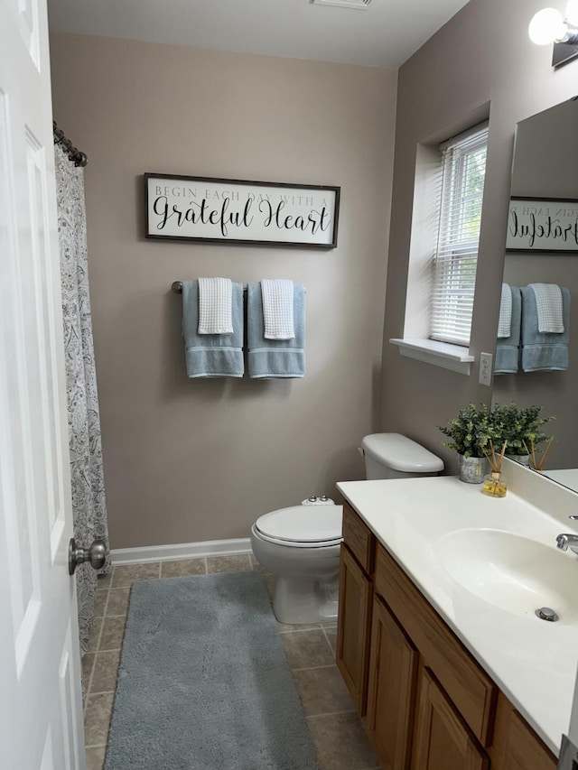 full bathroom with tile patterned flooring, baseboards, vanity, and toilet