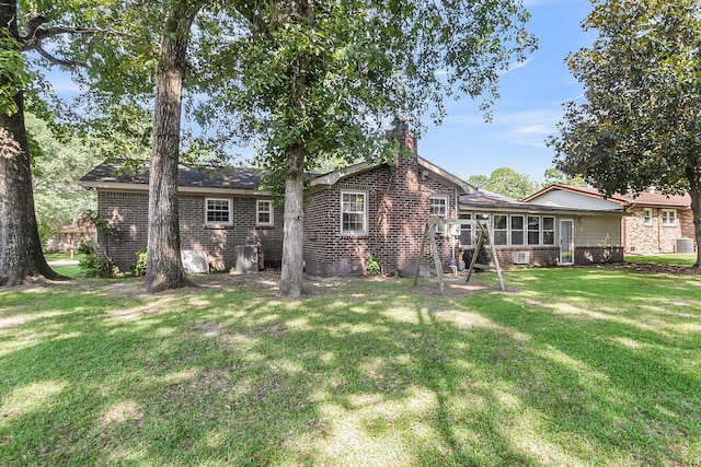 131 Wedgewood Cir, Goose Creek, SC 29445 - rear view of house with brick siding, a yard, a chimney, and a sunroom