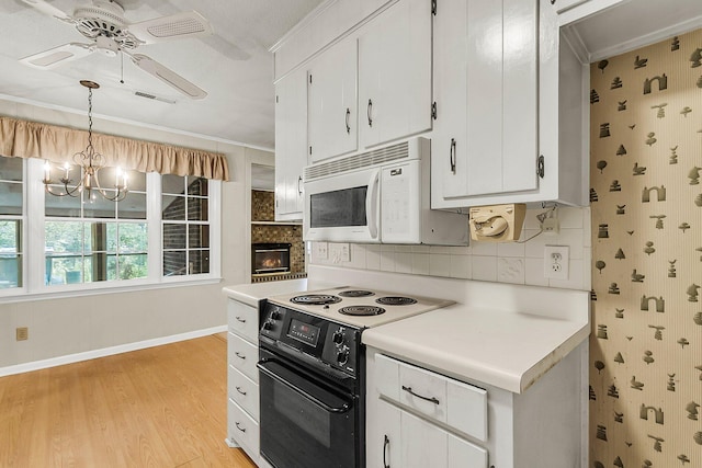 131 Wedgewood Cir, Goose Creek, SC 29445 - kitchen with black electric range oven, white microwave, a chandelier, light wood-style flooring, and a ceiling fan