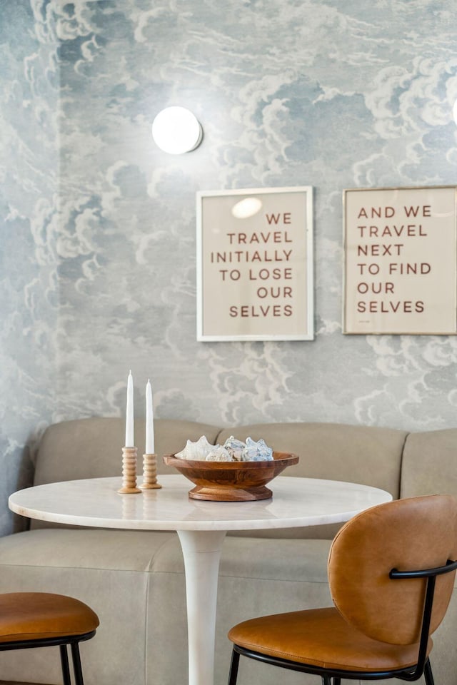 dining room featuring breakfast area and wallpapered walls