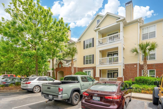 view of property featuring uncovered parking