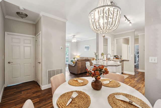 dining space featuring visible vents, dark wood finished floors, ceiling fan with notable chandelier, and baseboards