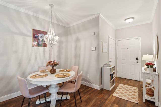 dining room with baseboards, ornamental molding, dark wood finished floors, and an inviting chandelier