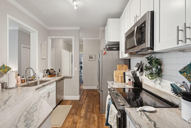 kitchen featuring white cabinets, light stone countertops, appliances with stainless steel finishes, and a sink