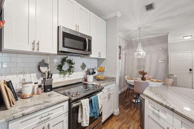 kitchen with crown molding, dark wood-style flooring, white cabinets, appliances with stainless steel finishes, and visible vents