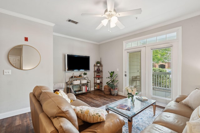 living area featuring visible vents, crown molding, wood finished floors, baseboards, and a ceiling fan