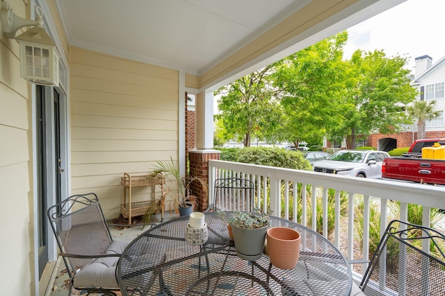 balcony featuring a porch and outdoor dining space