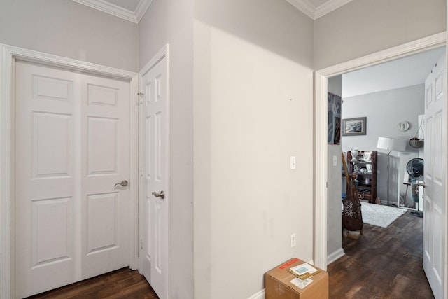 hallway featuring crown molding, dark wood-style flooring, and baseboards