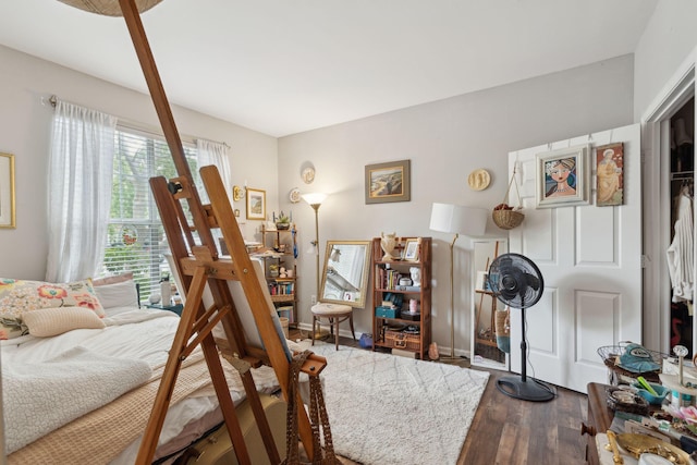 bedroom with dark wood-style flooring