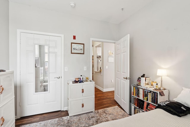 bedroom with baseboards and wood finished floors
