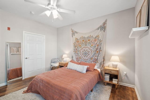 bedroom featuring baseboards, ceiling fan, and wood finished floors