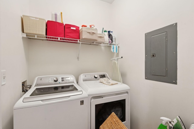 washroom featuring laundry area, washer and clothes dryer, and electric panel