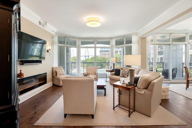 living area with light wood-style floors, expansive windows, and ornamental molding