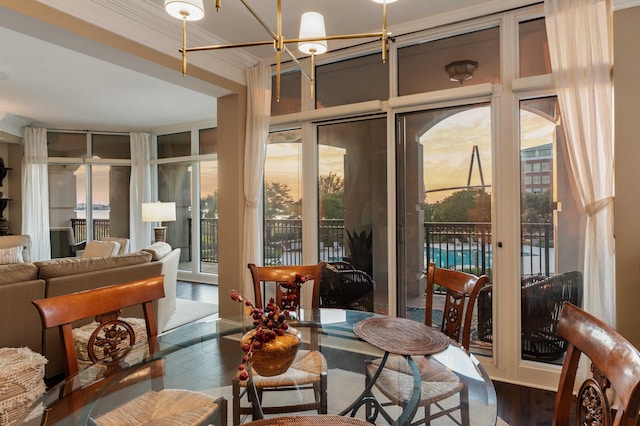 sunroom / solarium with a chandelier