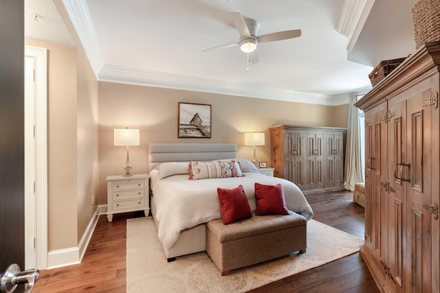 bedroom with hardwood / wood-style floors, crown molding, baseboards, and ceiling fan