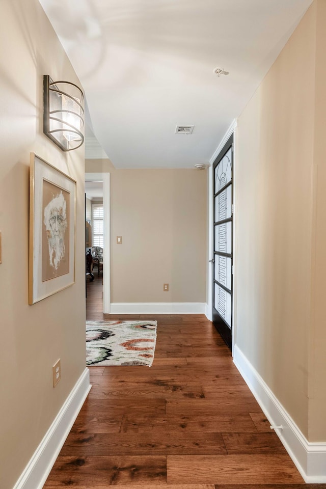hall with dark wood finished floors and baseboards
