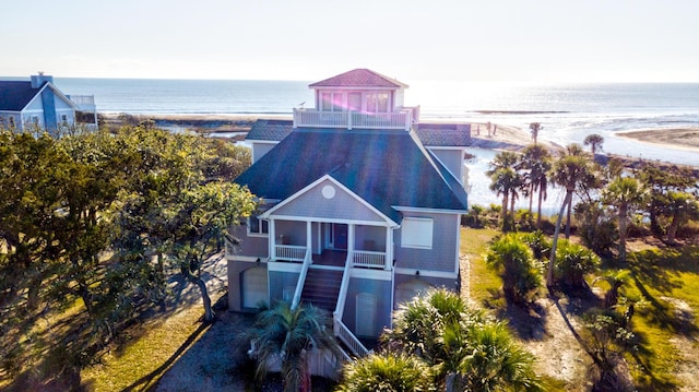 birds eye view of property featuring a water view and a beach view