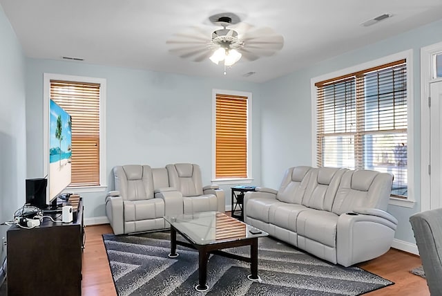 living room with hardwood / wood-style flooring and ceiling fan