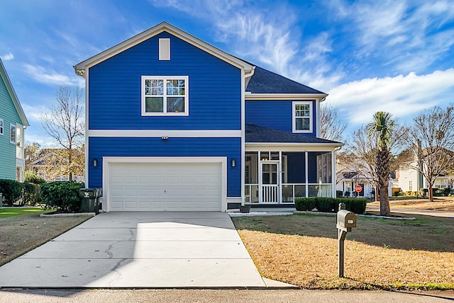 view of front property with a front yard, a garage, and a sunroom