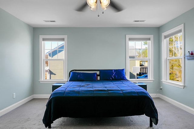 bedroom with light carpet and ceiling fan