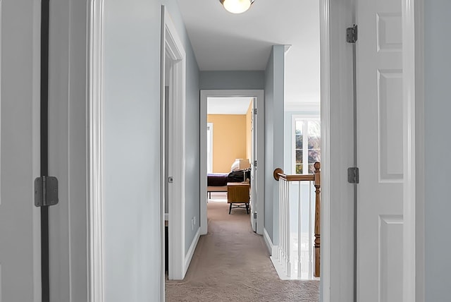 hall with light colored carpet