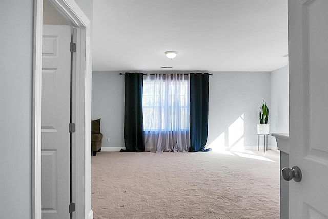 spare room with light colored carpet