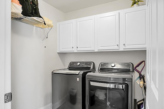 washroom featuring cabinets and separate washer and dryer