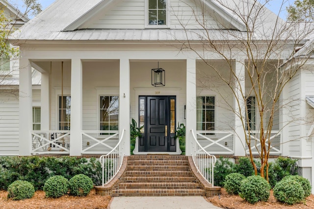 doorway to property with metal roof