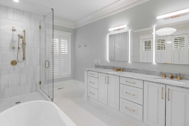 full bathroom featuring double vanity, a shower stall, ornamental molding, and a sink