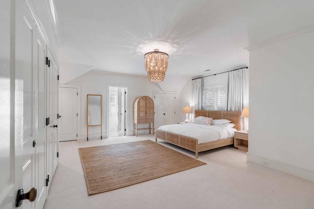 bedroom with a chandelier, ornamental molding, and light colored carpet